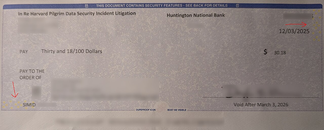 A cheque leaf and a pen held in the hand, symbolising a dishonoured cheque complaint