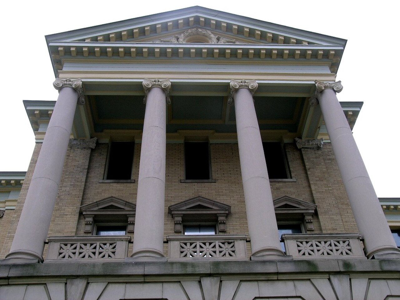 Columned facade of a courthouse where an action for abatement may be heard