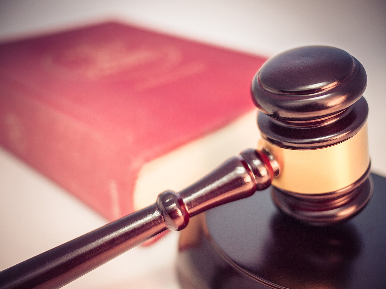 A gavel and a law book symbolising the enforcement and court process