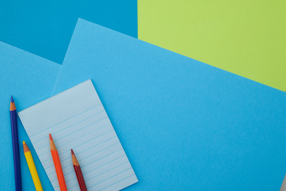 Illustrative image on an education theme showing a desk arranged with a school bag and pencils