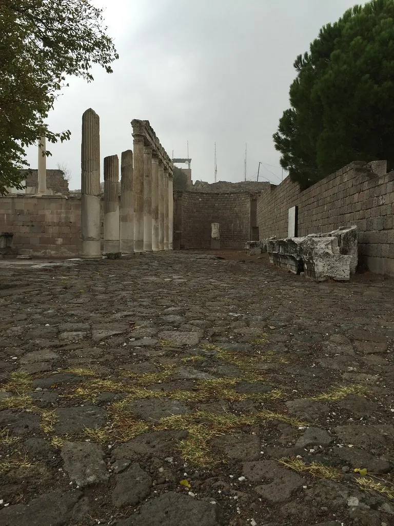 Bergama antik kentinde taş döşeli yol ve sütun dizisi, bulutlu bir günde